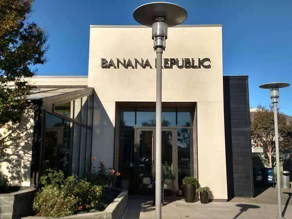 Exterior of Banana Republic store with smooth plaster finish and large glass windows.