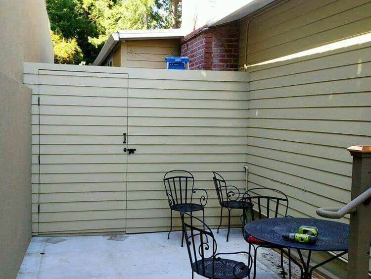 Outdoor patio with concrete floor, metal furniture, and wooden fence in Mill Valley.