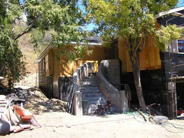 Partially built stucco home with curved staircase at a construction site in Greenbrae.